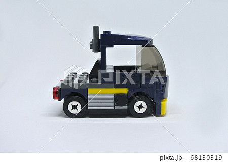 Blue toy truck made from plastic brick and isolated on white background.  68130319