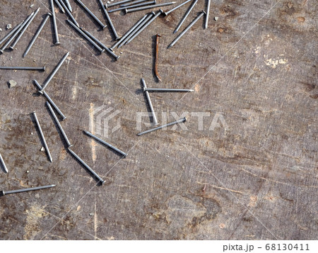 Nails are randomly scattered over ply wood 68130411