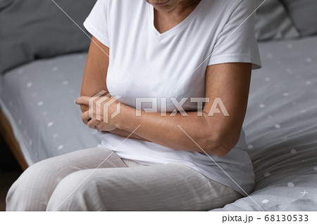 Elderly woman woke up suffers from abdominal pain Elderly woman woke up suffers from abdominal pain 68130533