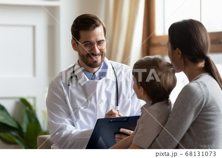 Smiling male pediatrician listening to young mother with kid son. Smiling male pediatrician listening to young mother with kid son. 68131073
