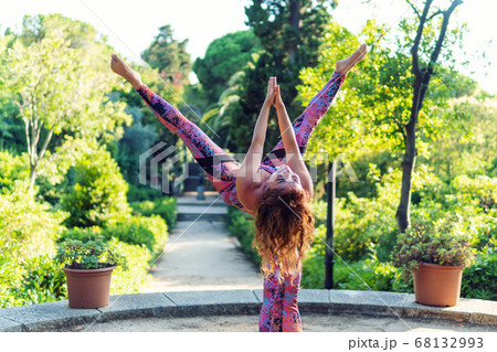 Two beautiful women doing acroyoga in the garden or park 68132993