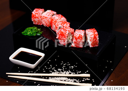 Sushi with salmon. Soy sauce, red caviar. Sushi on a black background. Sushi with salmon. Soy sauce, red caviar. Sushi on a black background. 68134193