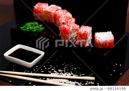 Sushi with salmon. Soy sauce, red caviar. Sushi on a black background. Sushi with salmon. Soy sauce, red caviar. Sushi on a black background. 68134199