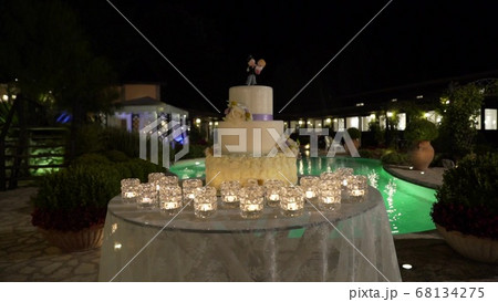 large wedding cake against the background of the pool, slider, night 68134275