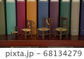 wedding rings are hanging on the play chairs on the background of books 68134279