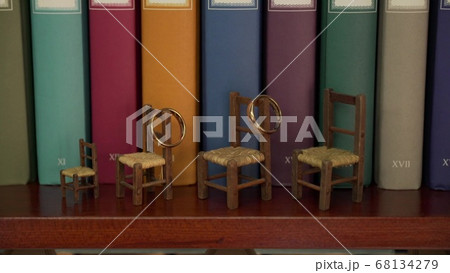 wedding rings are hanging on the play chairs on the background of books 68134279