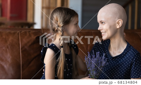 Loving little daughter greeting sick young mom 68134804