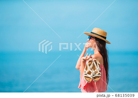 Young beautiful woman having fun on tropical seashore. 68135039