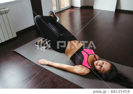 Fit woman doing sport exercises in her living room 68135459