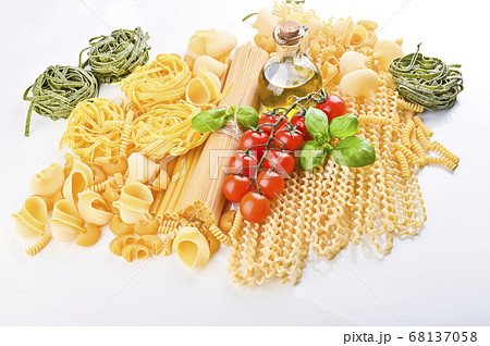Pasta with fresh tomatoes, basil and olive oil on light shabby rustic background, top view, border Pasta with fresh tomatoes, basil and olive oil on light shabby rustic background, top view, border 68137058