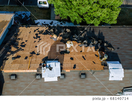 Working roofers on replacing the roof of 68140714