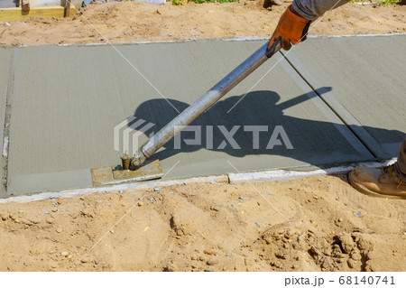 Worker plastering the concrete cement during 68140741