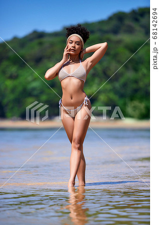 Young asian girl in bikini posing at tropical 68142694