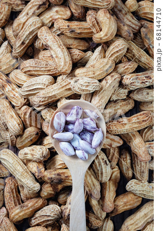 Peanuts close up on wood background Peanuts close up on wood background 68144710