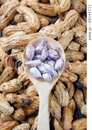 Peanuts close up on wood background Peanuts close up on wood background 68144711