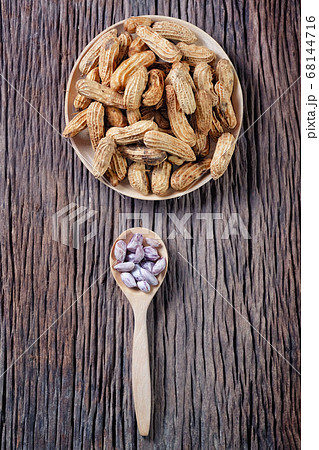 Peanuts on blue wood background Peanuts on blue wood background 68144716