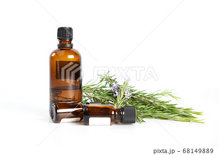 Bottle of rosemary essential oil with fresh 68149889