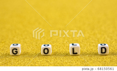 gold word formed by white dices with black letters on golden background 68150561