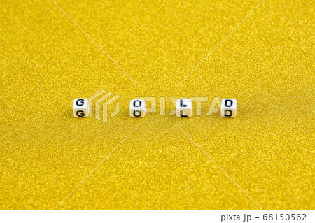gold word formed by white dices with black letters on golden background 68150562