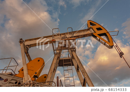 Petroleum concept. Oil pump rig. Oil and gas production. Oilfield site. Pump Jack are running. Drilling derricks for fossil fuels output and crude oil production. Global crisis. War on oil prices. Petroleum concept. Oil pump rig. Oil and gas production. Oilfield site. Pump Jack are running. Drilling derricks for fossil fuels output and crude oil production. Global crisis. War on oil prices. 68154333