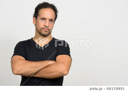 Portrait of handsome bearded Hispanic man with curly hair Portrait of handsome bearded Hispanic man with curly hair 68159891