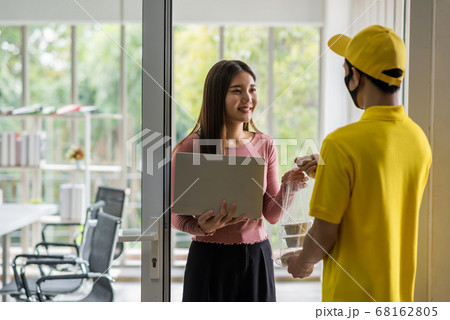 Office worker take food from deliveryman in mask Office worker take food from deliveryman in mask 68162805