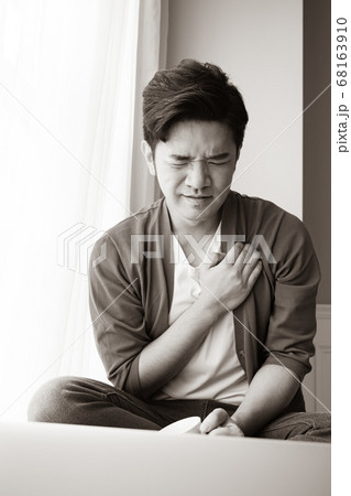 Young asian man having heart attack Young asian man having heart attack 68163910