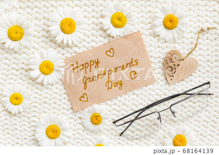 Happy Grandparents day background. Flowers on white knitted background 68164139