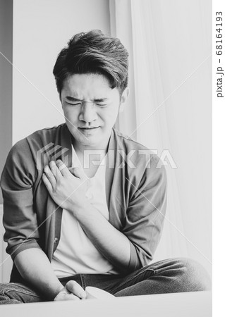 Young asian man having heart attack 68164193