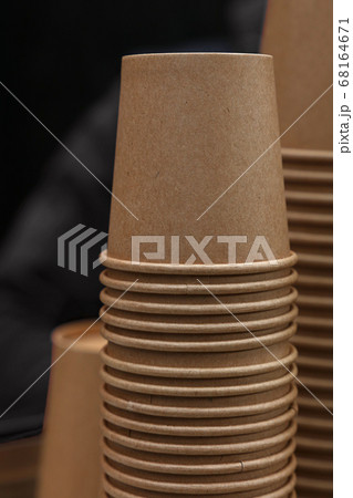 Stack of brown coffee paper cups close up Stack of brown coffee paper cups close up 68164671