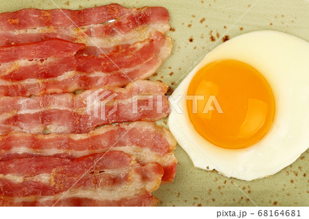 Close up sunny side egg and bacon on plate Close up sunny side egg and bacon on plate 68164681