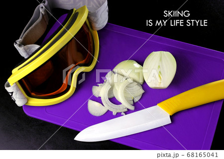Onion sliced on a cutting board with a yellow 68165041