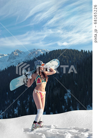 Girl in a bathing suit with a snowboard on her 68165226