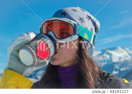 Girl drinking from paper cup with a picture of a 68165227