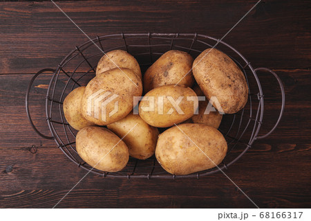 Potatoes in wicker basket on brown wooden rustic 68166317