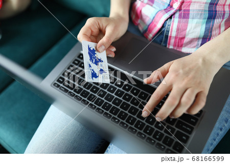 Female hands holding a credit card close up Female hands holding a credit card close up 68166599