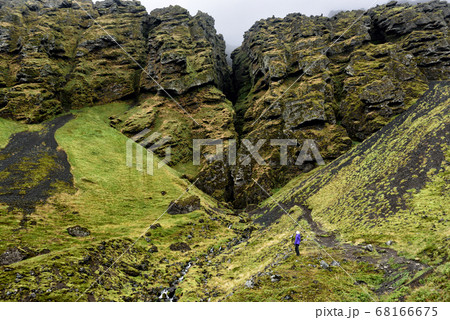 Iceland hiker tourist sightseeing visiting Raudfeldsgja Canyon gorge rift nature landscape on the Snaefellsnes peninsula, West Iceland Iceland hiker tourist sightseeing visiting Raudfeldsgja Canyon gorge rift nature landscape on the Snaefellsnes peninsula, West Iceland 68166675