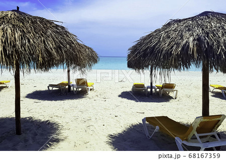 Cuban beach, umbrellas and sunbeds with Atlantic Ocean in background - Varadero, Cuba  68167359