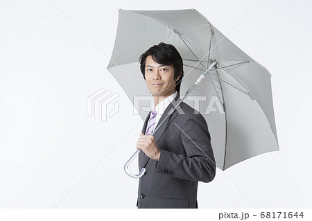 傘を差すビジネスマンの写真素材