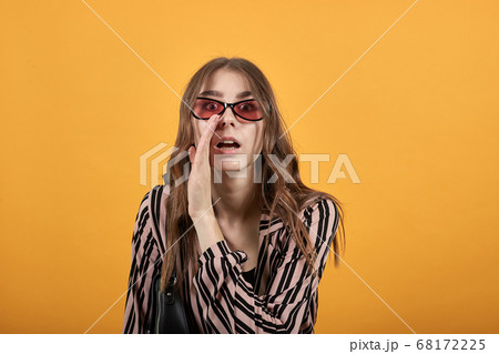 Talking Girl Tells Gossip In Secret, Holds The Palm Of Hand To Her Mouth 68172225