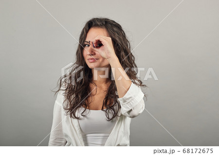Making glasses of fingers, looking at camera smiling, funny, hold hands eyes 68172675