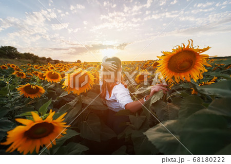 Rear view of a young girl in the middle of a rural Rear view of a young girl in the middle of a rural 68180222