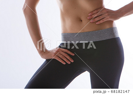 the result of sports exercises: a toned stomach close-up on a white background. Influence of diet 68182147