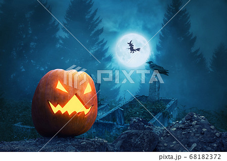 Spooky pumpkin lantern in the scary graveyard for Halloween Spooky pumpkin lantern in the scary graveyard for Halloween 68182372