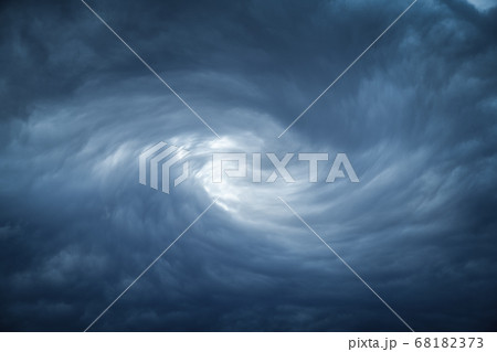 The eye of a tornado starts to create a vortex from grey couds 68182373