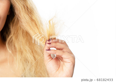 Young woman holding hair, decide to hair care Young woman holding hair, decide to hair care 68182433