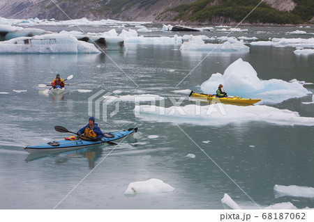 Sea kayakers paddling in glacial lagoon at a glacier terminus on the coast of Alaska 68187062