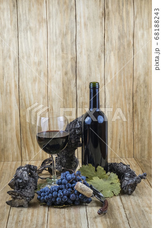 black grapes with a vine and a glass of wine and a bottle black grapes with a vine and a glass of wine and a bottle 68188243