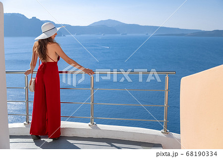 young woman enjoying view of Santorini, Greece young woman enjoying view of Santorini, Greece 68190334