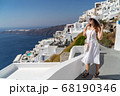 Europe Greece Santorini travel vacation woman on famous santorini Oia island travel destination. Happy young tourist woman. Summer wanderlust. 68190346
